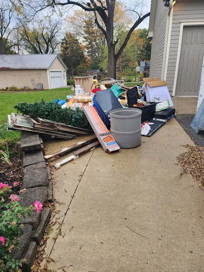 Dumpster being loaded with debris for Estate Cleanout Dumpster Rental in Brooklyn Center